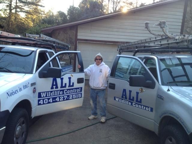 Matthew Field with All Wildlife Control trucks